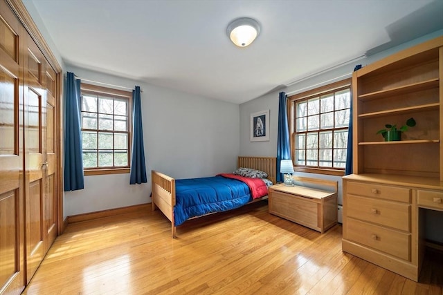 bedroom featuring baseboards and light wood-type flooring