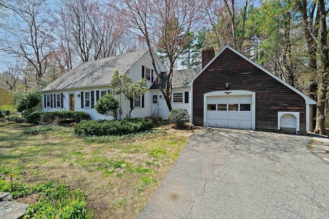 view of front of home with aphalt driveway and a chimney