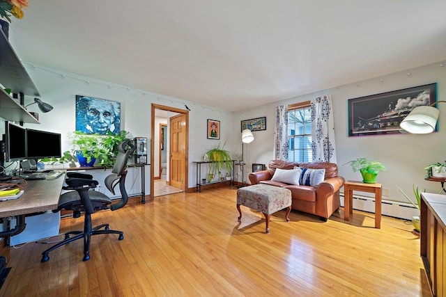 office area with baseboard heating and light wood-style flooring