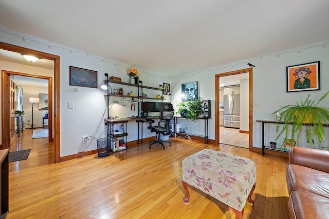 office area with baseboards and wood finished floors