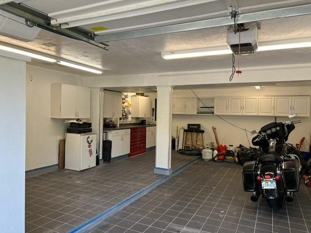 21 Parlee St, Salem, MA 01970 - garage with a garage door opener and baseboards