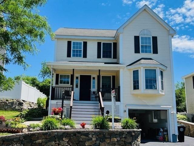 21 Parlee St, Salem, MA 01970 - view of front facade featuring covered porch, a garage, driveway, and stairway