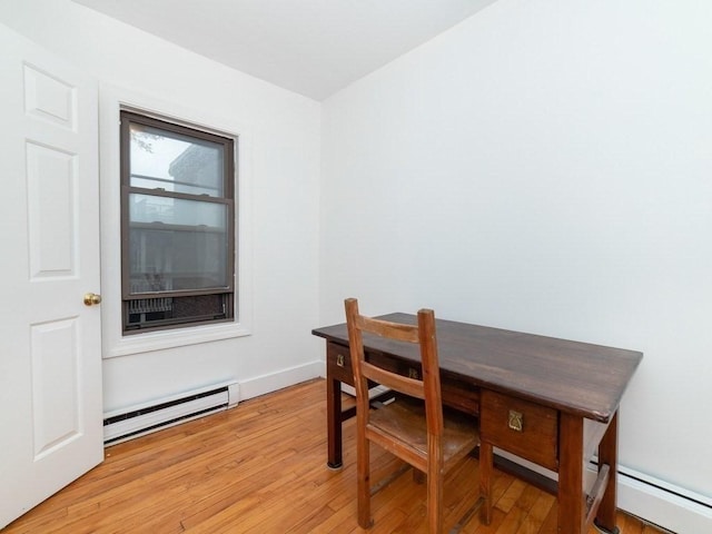 187 W 5th St, Boston, MA 02127 - dining space featuring a baseboard radiator, light wood-type flooring, and a desk