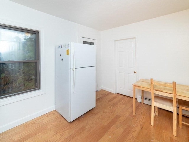 187 W 5th St, Boston, MA 02127 - kitchen with freestanding refrigerator, light wood-type flooring, and a baseboard heating unit