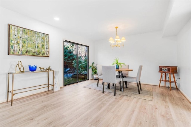 dining room with a chandelier and light hardwood / wood-style floors