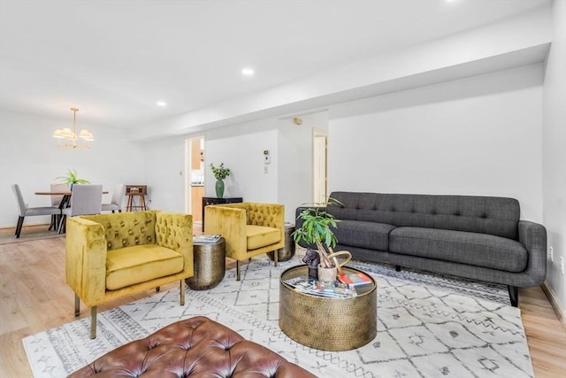 living room with a chandelier and light hardwood / wood-style floors