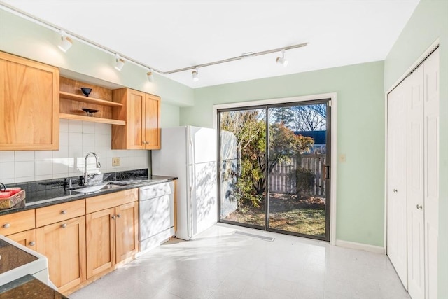 kitchen featuring decorative backsplash, sink, white dishwasher, and range