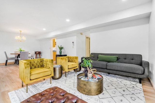 living room featuring an inviting chandelier and hardwood / wood-style flooring