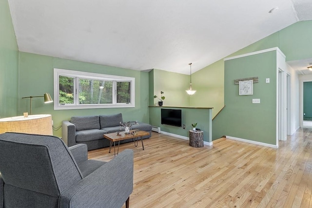 525 Flat Hill Rd, Lunenburg, MA 01462 - living room with lofted ceiling, light wood-style flooring, baseboards, and a baseboard radiator