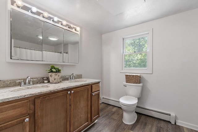 525 Flat Hill Rd, Lunenburg, MA 01462 - bathroom featuring a baseboard radiator, double vanity, wood finished floors, and toilet