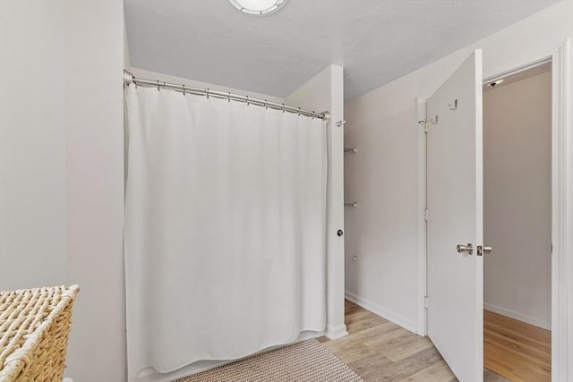 525 Flat Hill Rd, Lunenburg, MA 01462 - bathroom with wood finished floors, a shower with curtain, and baseboards