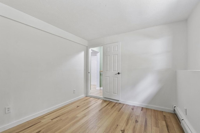 525 Flat Hill Rd, Lunenburg, MA 01462 - empty room featuring a baseboard heating unit, light wood-type flooring, and baseboards
