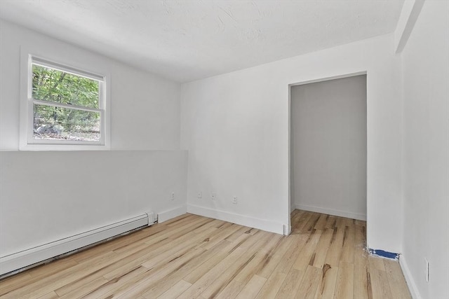525 Flat Hill Rd, Lunenburg, MA 01462 - empty room featuring a baseboard radiator, light wood-style flooring, and baseboards