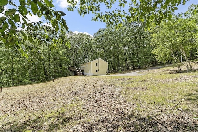 525 Flat Hill Rd, Lunenburg, MA 01462 - view of yard with a deck and a wooded view