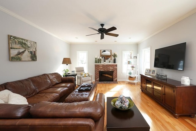 living room featuring ceiling fan, ornamental molding, plenty of natural light, and light hardwood / wood-style flooring