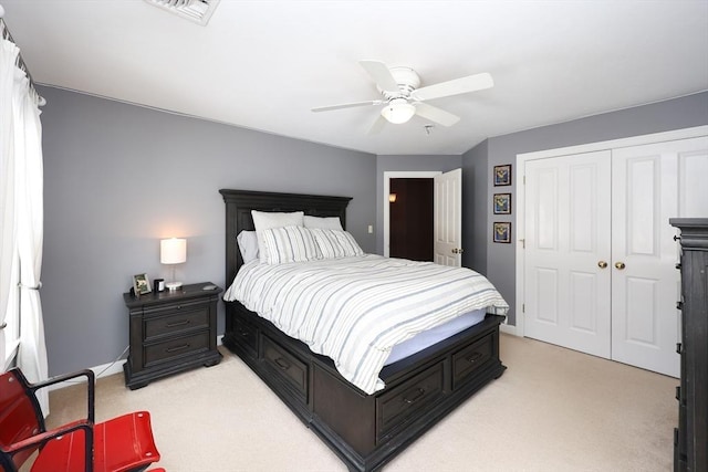 carpeted bedroom featuring ceiling fan and a closet