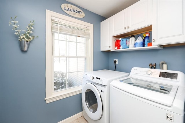 clothes washing area featuring independent washer and dryer and cabinets