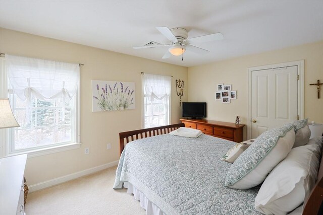 bedroom featuring light colored carpet and ceiling fan