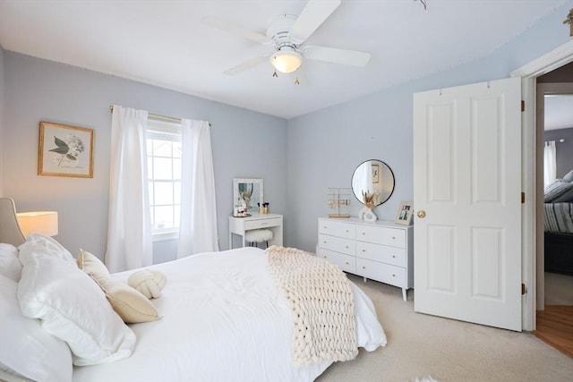 bedroom with ceiling fan and light colored carpet