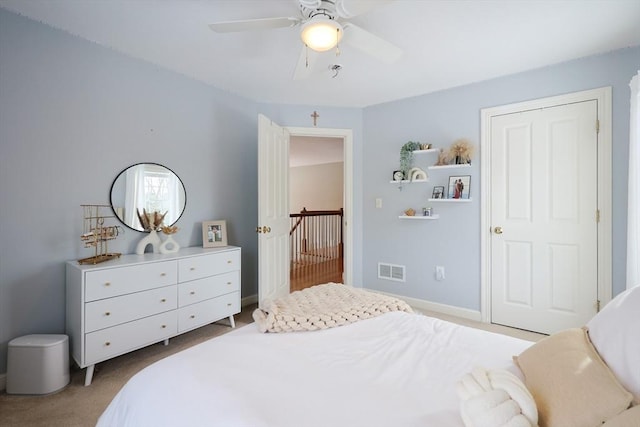 bedroom with light carpet and ceiling fan