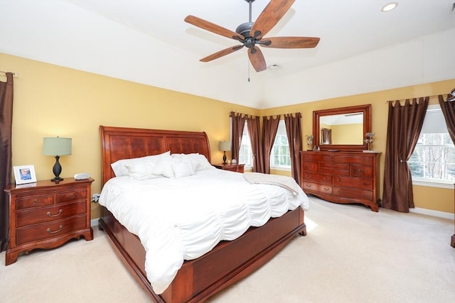 bedroom with ceiling fan and light carpet