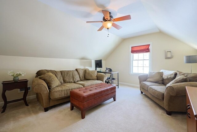 carpeted living room with ceiling fan and lofted ceiling