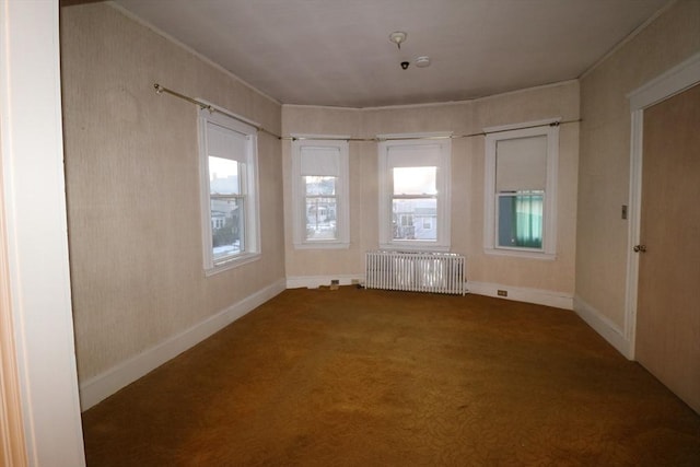 empty room with carpet and radiator