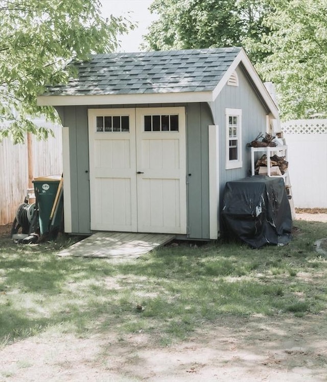 view of shed with fence