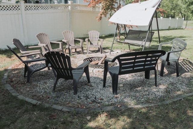view of yard with an outdoor fire pit and fence