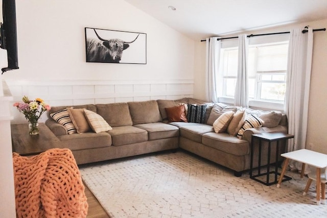 living area featuring lofted ceiling and wood finished floors