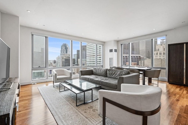 living room with a view of city, light wood-type flooring, and recessed lighting