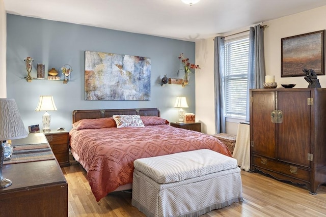 bedroom featuring multiple windows and light hardwood / wood-style flooring