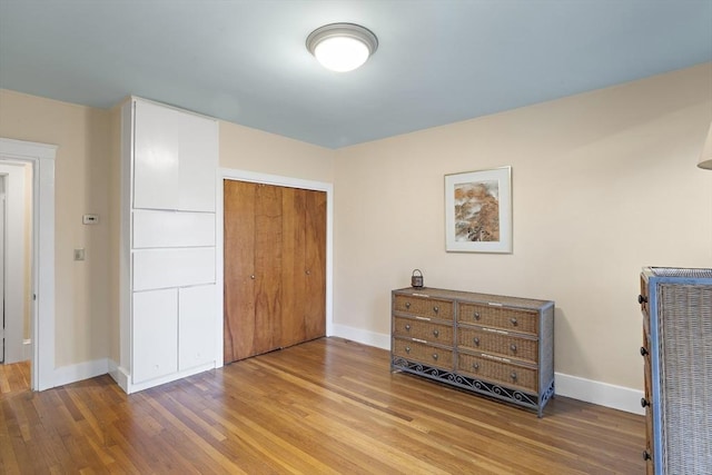 bedroom featuring hardwood / wood-style floors and a closet