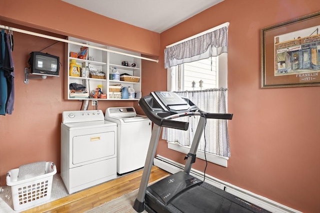 exercise area with light wood-type flooring and washer and clothes dryer