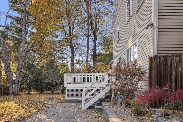 exterior space with a wooden deck and a patio