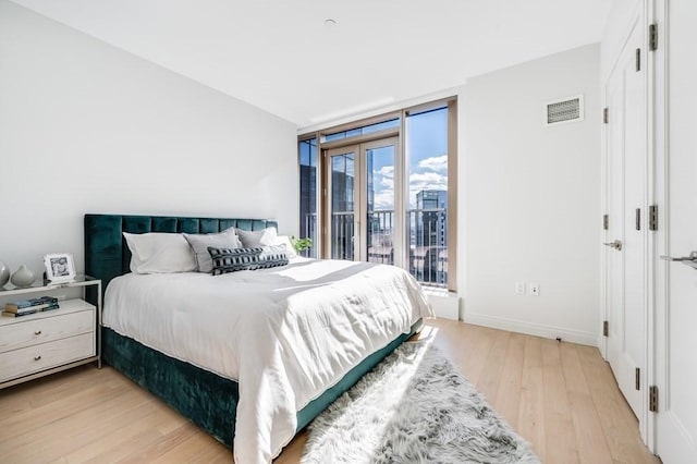 bedroom featuring access to outside and light wood-type flooring