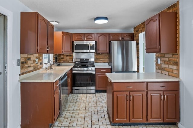 kitchen with a sink, stainless steel appliances, backsplash, and light countertops