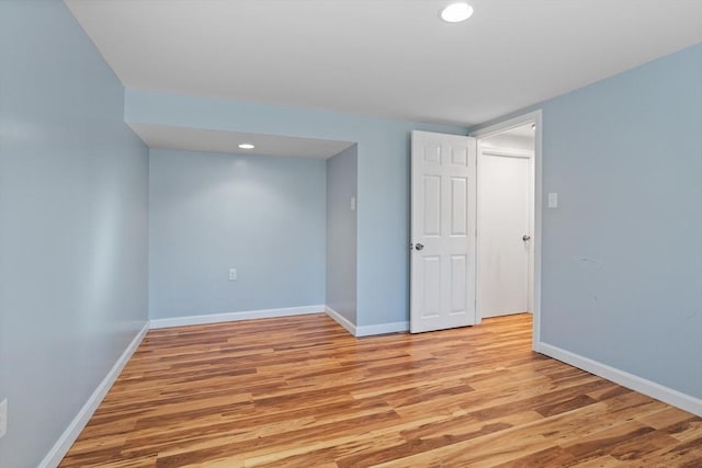 unfurnished room with light wood finished floors and baseboards