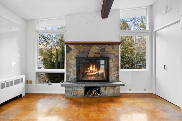 unfurnished living room featuring beam ceiling, radiator heating unit, a fireplace, and plenty of natural light