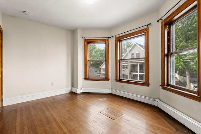 27 Chilcott Pl Unit 2, Boston, MA 02130 - empty room with wood finished floors, a baseboard heating unit, baseboards, and a smoke detector