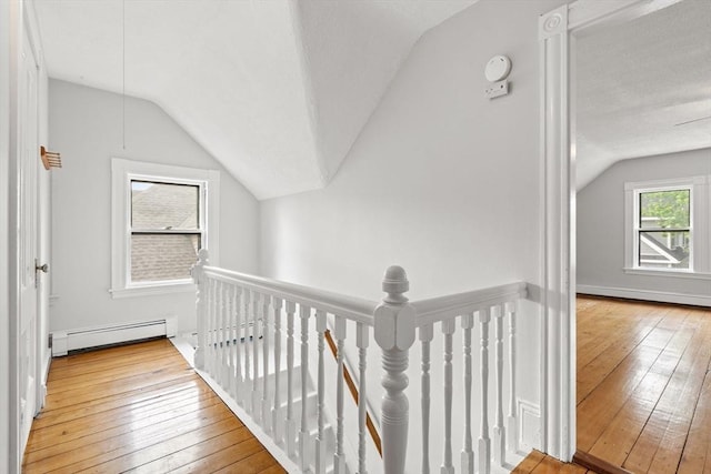 27 Chilcott Pl Unit 2, Boston, MA 02130 - hall featuring an upstairs landing, baseboard heating, vaulted ceiling, and hardwood / wood-style floors