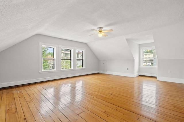 27 Chilcott Pl Unit 2, Boston, MA 02130 - additional living space featuring a baseboard heating unit, a textured ceiling, light wood-type flooring, a ceiling fan, and vaulted ceiling