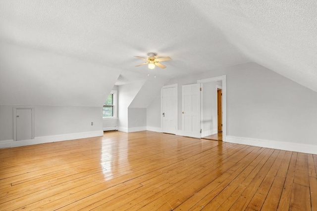 27 Chilcott Pl Unit 2, Boston, MA 02130 - bonus room featuring ceiling fan, a textured ceiling, light wood-style flooring, vaulted ceiling, and baseboards