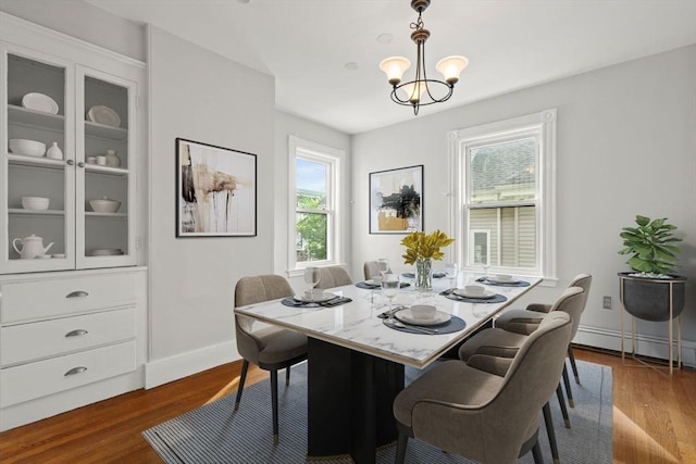 27 Chilcott Pl Unit 2, Boston, MA 02130 - dining space featuring dark wood finished floors, a baseboard heating unit, a chandelier, and baseboards