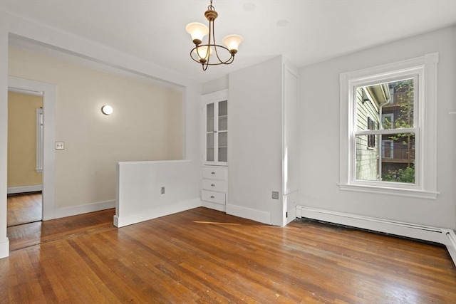 27 Chilcott Pl Unit 2, Boston, MA 02130 - unfurnished dining area featuring hardwood / wood-style flooring, a chandelier, and baseboards