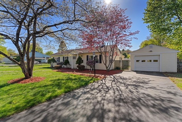 122 Baldwin Ave, Framingham, MA 01701 - ranch-style house featuring fence, a detached garage, a front yard, an outdoor structure, and driveway