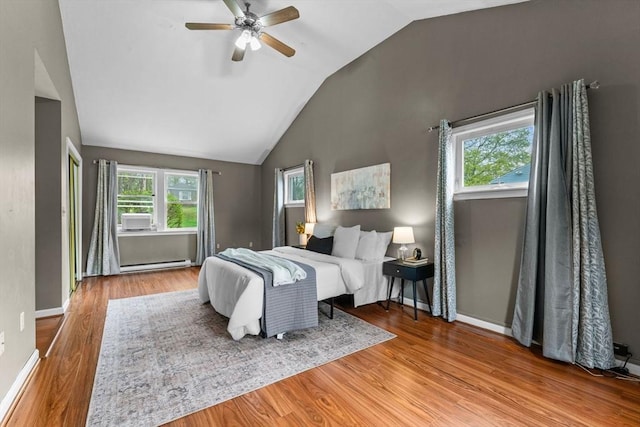 122 Baldwin Ave, Framingham, MA 01701 - bedroom featuring ceiling fan, baseboard heating, baseboards, wood finished floors, and vaulted ceiling