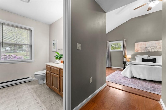 122 Baldwin Ave, Framingham, MA 01701 - bathroom featuring ceiling fan, vaulted ceiling, vanity, a baseboard heating unit, and toilet
