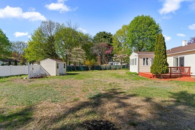 122 Baldwin Ave, Framingham, MA 01701 - view of yard with a storage shed, an outbuilding, a wooden deck, and a fenced backyard