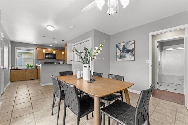122 Baldwin Ave, Framingham, MA 01701 - dining area featuring light tile patterned floors, baseboards, and a ceiling fan